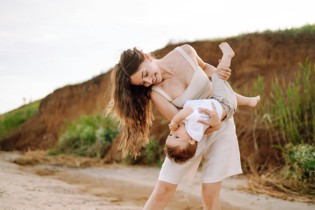 Beautiful mother and child resting on the beach. Active lifestyle. Happy childhood.